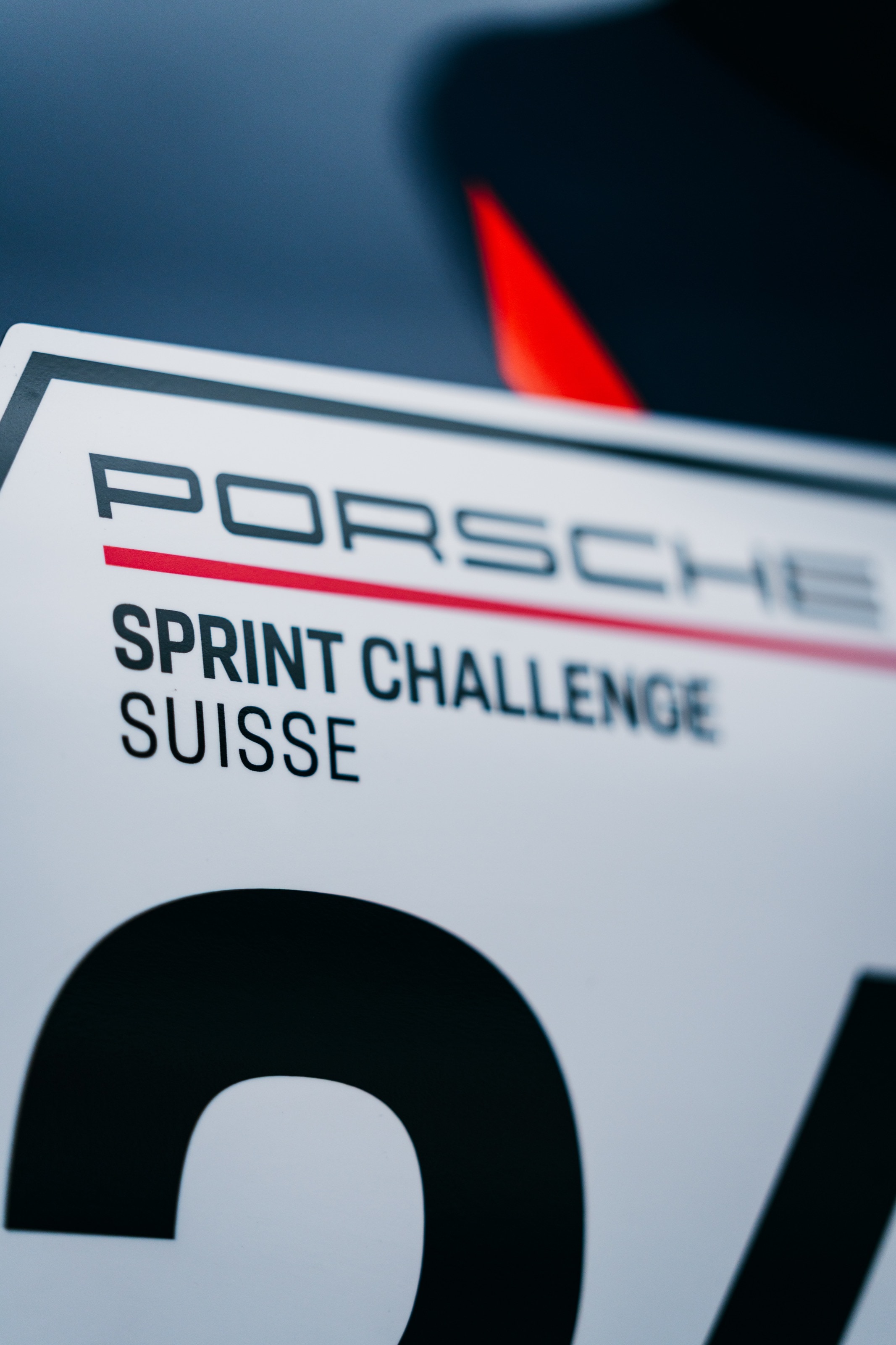Aufkleber „Porsche Sprint Challenge Suisse“ mit Startnummer auf der Flanke des Autos
